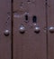 Keyhole in an old door with an interesting texture, a remnant of