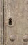 Keyhole in an old paneled wooden door;