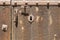 Keyhole in an old paneled wooden door with antique door handle;
