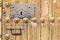 Keyhole in an old paneled wooden door with antique door handle;