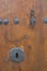 Keyhole in a rustic door.