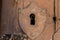 A keyhole with a shield in the old door.