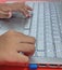KEYPAD LAPTOP AND CHILD& x27;S HAND, WHITE COLOR