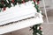 Keys on white upright piano with christmas decor