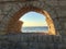 Keysaria. Israel. 2 people sitting on Roman aqueduct .caesarea.