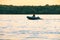 Khabarovsk, Russia - Jul 19, 2019: People in an inflatable boat floating on the Amur river along the shore