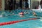 Khabarovsk, Russia - May, 19, 2019: children swimming Breaststroke. Indoor swimming pool with clear blue water