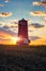 Khablovskiy lighthouse standing in the field at sunset, scenic landscape. Unique lighthouse on the border of Kherson and Mykolaiv