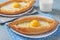 Khachapuri in Adjarian, Open pies with suluguni cheese and egg yolk in the form of a boat on plates on blue background