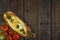 Khachapuri with fresh vegetables caucasian kitchen, close-up on a black wooden table. Adzharian khachapuri. View from above