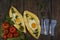 Khachapuri with fresh vegetables caucasian kitchen, close-up on a black wooden table. Adzharian khachapuri. View from above