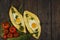 Khachapuri with fresh vegetables caucasian kitchen, close-up on a black wooden table. Adzharian khachapuri. View from above