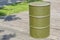 Khaki aluminum oil barrel stands on the street