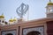 Khanda Sikh holy religious symbol at gurudwara entrance with bright blue sky image is taken at Sis Ganj Sahib Gurudwara in Chandni