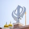 Khanda Sikh holy religious symbol at gurudwara entrance with bright blue sky image is taken at Sis Ganj Sahib Gurudwara in Chandni