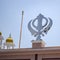 Khanda Sikh holy religious symbol at gurudwara entrance with bright blue sky image is taken at Sis Ganj Sahib Gurudwara in Chandni