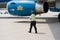 Khanh Hoa, Vietnam - July 30, 2016: Vietnamese security staff walking on aviation ground with airplane of Vietnam Airlines on back