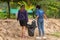 Khao Lak, Thailand, 1 june 2019: Asian women volunteers clean up trash and clean the beach of dirt and waste on international