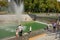 Kharkiv, Ukraine, August, 2019 People walk in a park, sit on benches near fountain. Clear sunny summer day. Women and men, kids