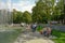 Kharkiv, Ukraine, August, 2019 People walk in a park, sit on benches near fountain. Clear sunny summer day. Women and men, kids