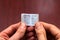 Kharkiv, Ukraine - February 8, 2021: Man holds miniature book titled My Fundamental Rights in the European Union. The Charter of