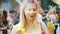Kharkiv, Ukraine - May 26, 2019: happy blonde girl gets Holi paints on her head