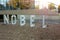 Kharkiv, Ukraine, September 2019 Letters installation of text NOBEL in front of modern urban building. Symbol of science and