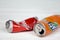 KHARKOV, UKRAINE - DECEMBER 8, 2020: Crumpled aluminium cans of Coca Cola and Fanta soft drinks on white wooden table. Two damaged