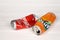 KHARKOV, UKRAINE - DECEMBER 8, 2020: Crumpled aluminium cans of Coca Cola and Fanta soft drinks on white wooden table. Two damaged