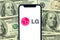 Kharkov, Ukraine - January 28, 2021: LG logo. Dollar bills background. Business company and money concept