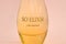 KHARKOV, UKRAINE - OCTOBER 21, 2019: Bottle of So Elixir perfume by Yves Rocher on bright pink color background