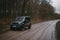 Khmelnytskyi, Ukraine - 01 April 2023: Suzuki Jimny JB43 gray colour. on the dirt road. Forest on background. Four wheel drive