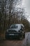 Khmelnytskyi, Ukraine - 01 April 2023: Suzuki Jimny JB43 gray colour. on the dirt road. Forest on background. Four wheel drive