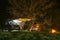 Khmelnytskyi, Ukraine - April 15, 2023: Suzuki Jimny with a roof rack Niken. Shelter from rain and wind. Tent and Bonfire. smoke