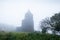 Khmer men walking to the ancient catholic church in the mist of morning, a remote settlement builds by the French colonialists in