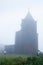 Khmer men walking to the ancient catholic church in the mist of morning, a remote settlement builds by the French colonialists in