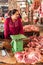 Khmer woman selling meat at traditional food marketplace