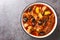 Khoresht Aloo Stewed lamb meat with dried plums or prunes, tomato, onion, potato, carrot and garlic closeup in the bowl.