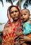 Khulna, Bangladesh: Woman in traditional clothes holding a baby