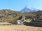Khumbila mountain peak rises above stone house