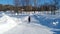 Khvalynsk, russia, - February , 2021 : boy rides cross country skiing with a small slide