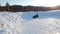 Khvalynsk, russia, - February , 2021: Father and his son having fun on a snow tube, at beauty winter day