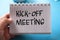 Kick-off meeting, text words typography written on paper against on blue background, life and business motivational inspirational