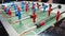 Kick off strike in table football game. Young people playing foosball. Side view