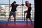 Kickboxing fighter hitting pads with trainer