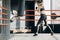 Kickboxing woman in airpods training punching bag in fitness studio fierce strength fit body