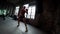 Kickboxing woman is training in fitness hall, striking punching bag by hands, sporty and strong lady