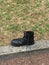 Kicked to the Curb- A solitary black boot on a curb