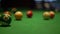 Kicking of balls with pool stick on table with green fabric