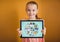 Kid against yellow wall holding tablet showing school doodles and blue background
